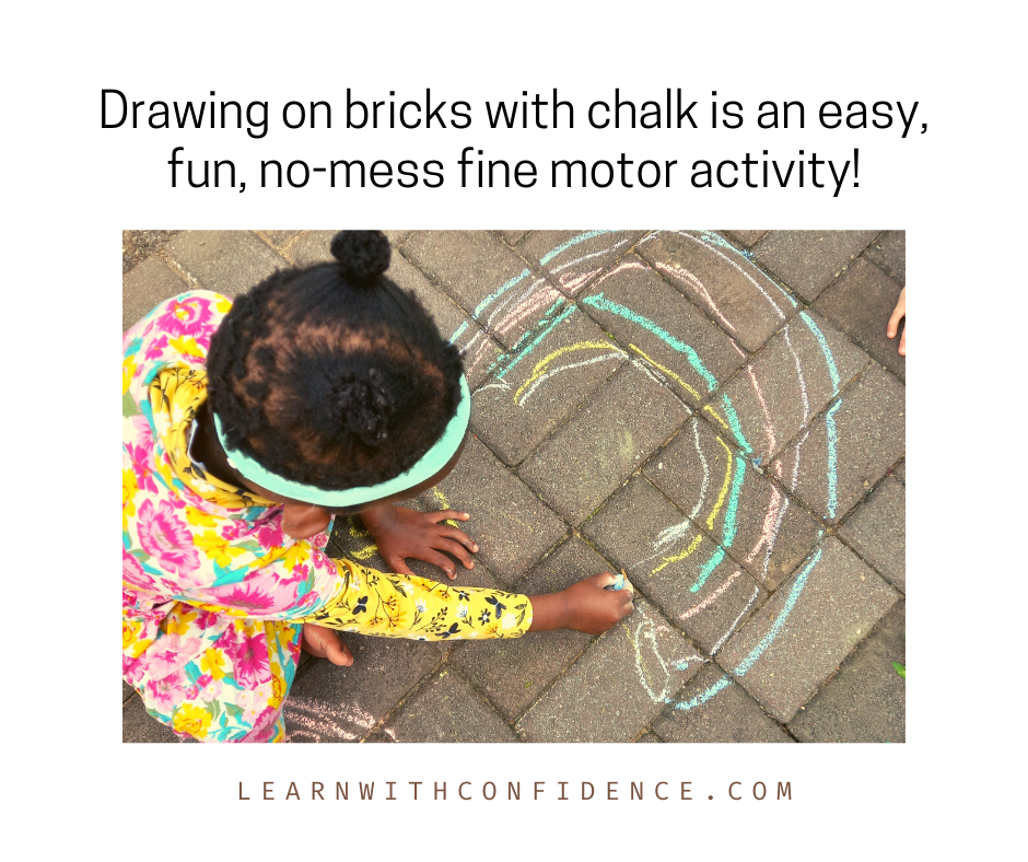 Girl draws a pictures of rainbow on sidewalk bricks using chalk. Drawing on brick with chalk is an easy, fun, no-mess fine motor activity.